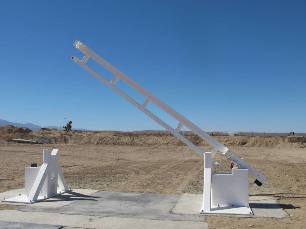 Delta Scientific beam barricade in the raised position, demonstrating robust perimeter security in a desert landscape, exemplifying Delta's advanced barrier technology for critical infrastructure protection.