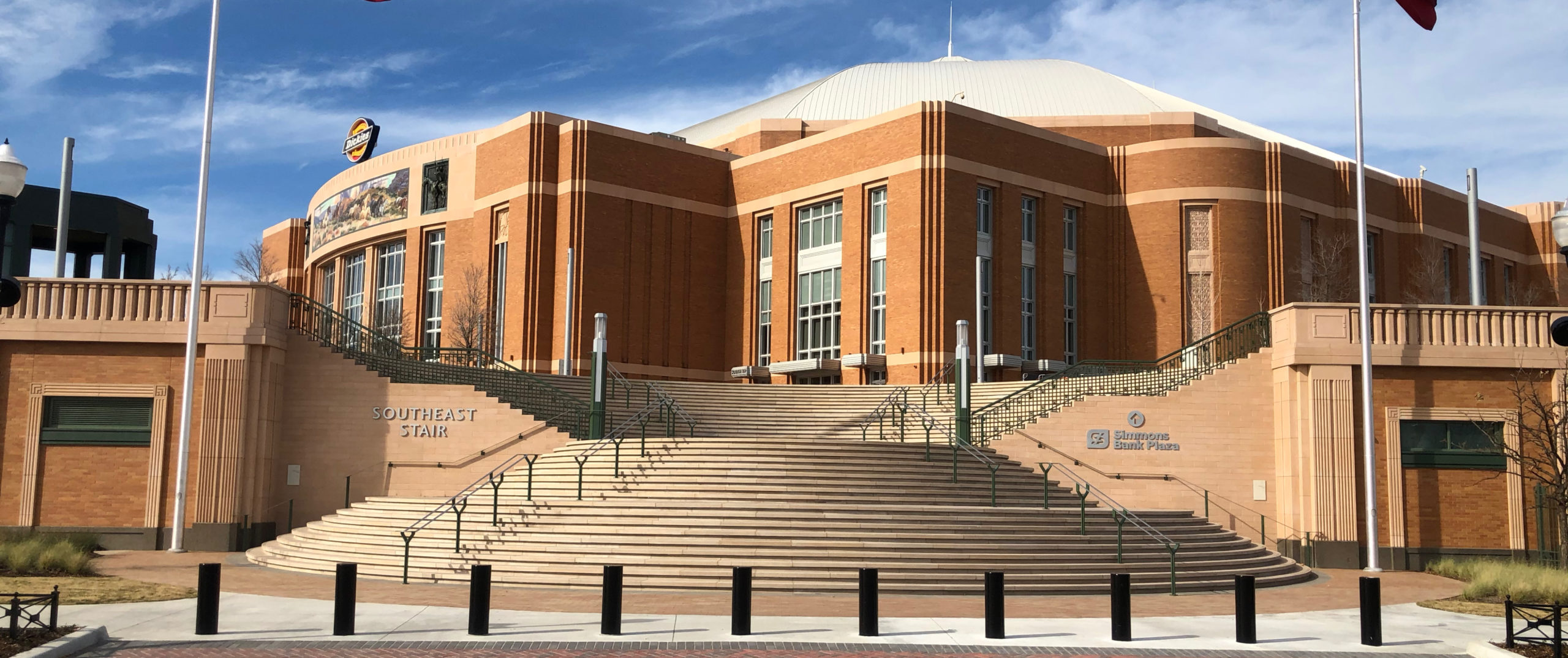 View of the exterior of Delta Scientific's corporate building, featuring the distinctive brick architecture and the Simmons Bank Plaza entrance, symbolizing the company's solid foundation and commitment to security and innovation in the high-security industry.