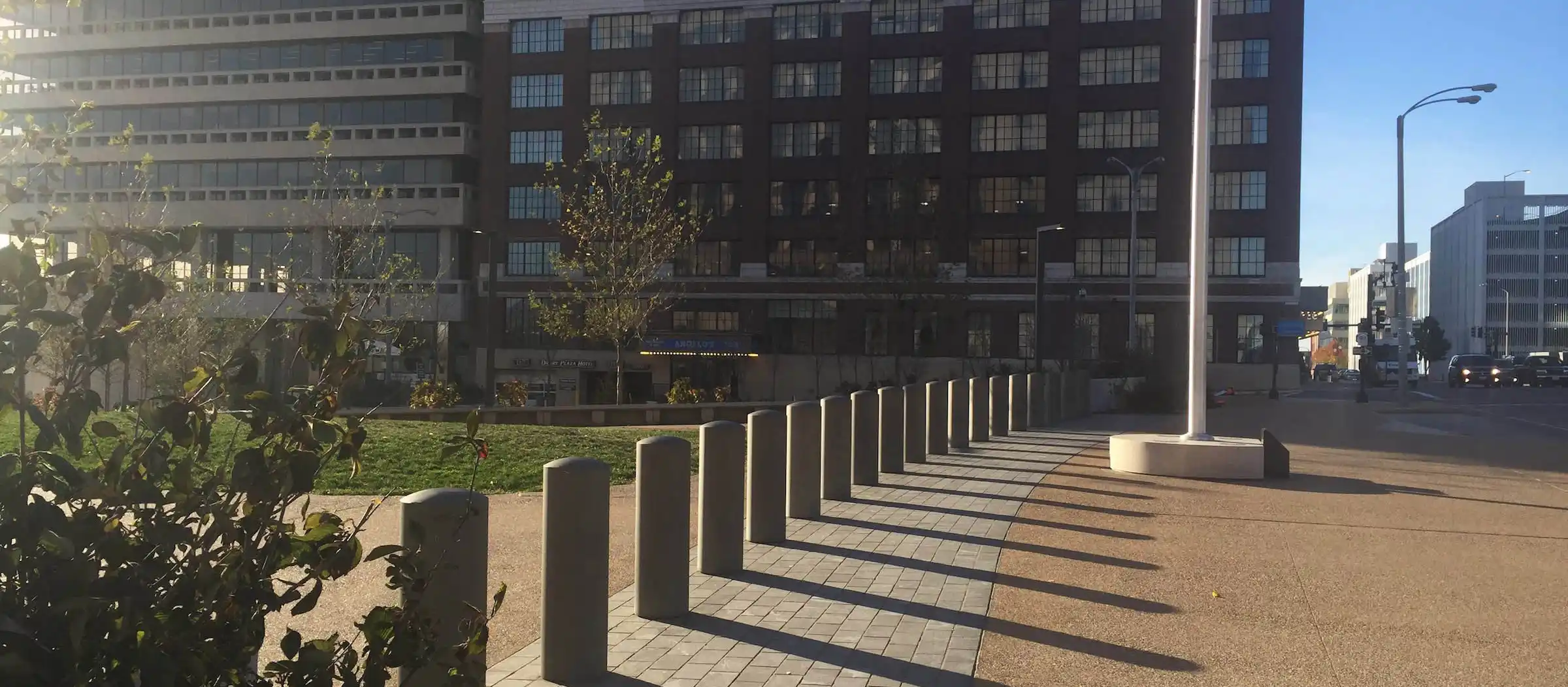 A Delta Scientific security installation outside a commercial building, featuring a row of durable bollards neatly aligned along the pathway, integrating seamlessly with the urban landscape while providing effective perimeter protection.